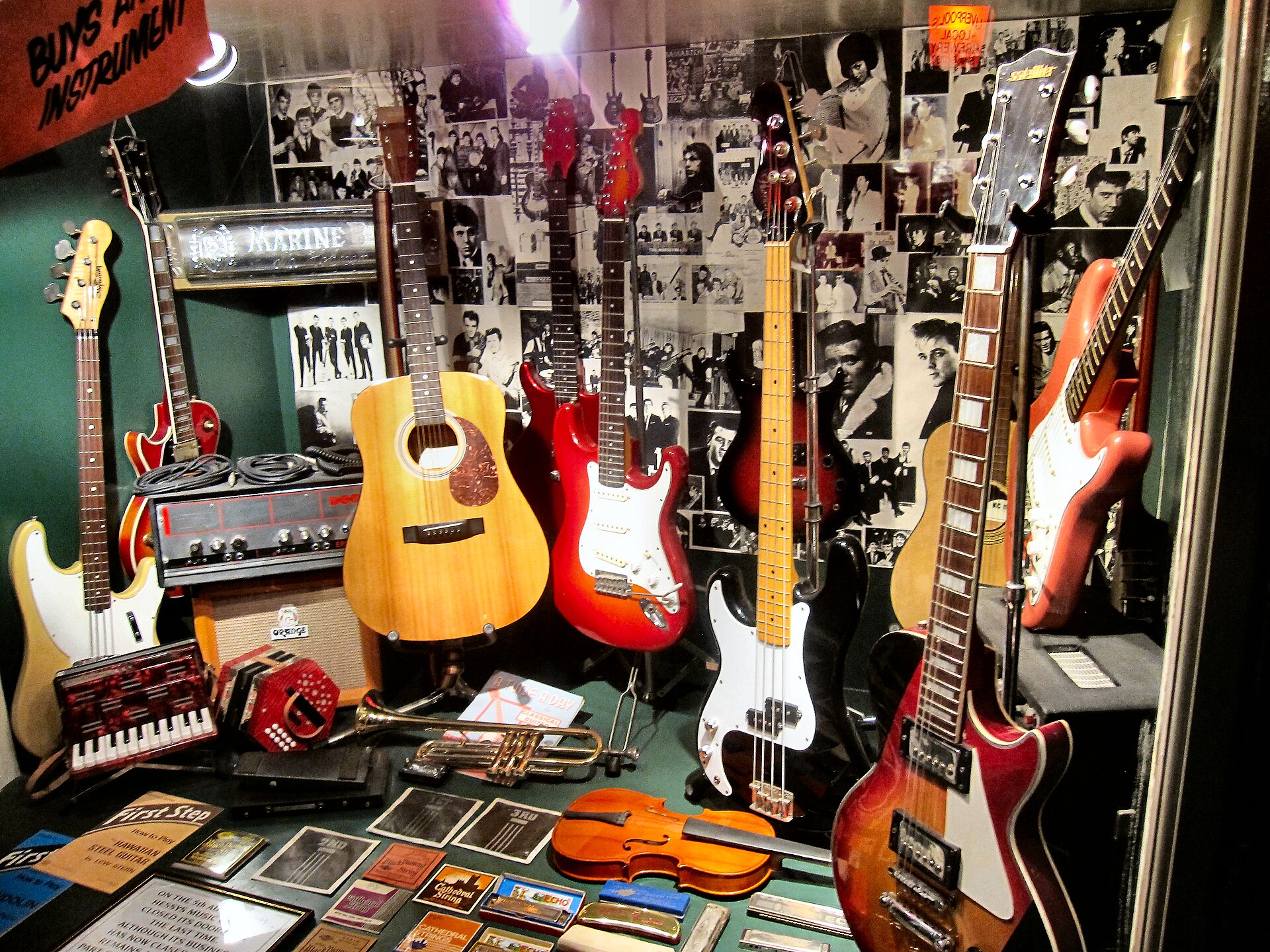 A reconstruction of how the shop front window looked . Taking the recording studio advice to heart, George Harrison and John Lennon, remembering Tony Sheridan’s impressive Gibson ES-175, decided they needed some Gibson power and finesse of their own and both fancied a J-160E acoustic. The only problem with that was the price. England, in 1962, was still recovering from two World Wars. The economy was still precarious and the average yearly wage was only £800. The Gibson J-160Es cost a cool £161 apiece, a steep price for even a successful live band of the time. Fortunately, The Beatles had a relatively wealthy manager in Brian Epstein and he co-signed for their payment plan at Rushworh's music store in Liverpool. But even Epstein took a year to pay off the guitars! The famous old music store was one of a select few Liverpool stores for U.S. guitars, which were still tough to acquire in England in 1962. It was the store where Paul McCartney’s father bought the 14-year-old Macca his first guitar. The Beatles purchased a lot of their early band instruments from Hessy’s music store in Liverpool, but their tab had passed £200 when Epstein came into the picture and he had to pay off the debt with a personal check. So Rushworth's it was for the Gibsons. A photo-op ceremony was set up from Bill Harry’s Merseybeat paper, and John and George were both presented with their prized sunburst Gibson J-160Es by James Rushworth. Peter Kaye took pictures for Merseybeat and the shot was printed in the paper with the caption, “John Lennon and George Harrison of The Beatles, seen at Rushworth’s when they received their Gibson guitars--the only ones of their type in the country--which were specially flown to England by jet from America.” The J-160Es arrived just in time for the historic London recording sessions the next day, September 11, when at EMI Abbey Road Studio Two London, Lennon played his brand spanking new Gibson J-160E on the sessions for The Beatles' first single. Their record was released just three weeks later, on October 5th, 1962, on the Parlophone label. “Love Me Do” made it to #17 on the U.K singles chart. The Beatles had arrived.
